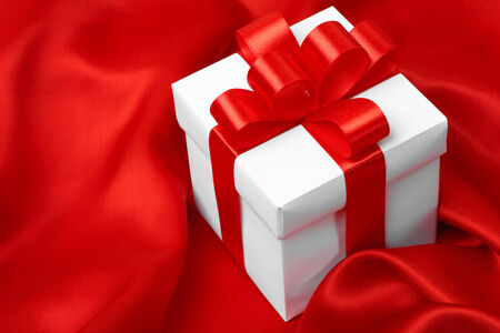 gift on red satin background. studio shotの写真素材