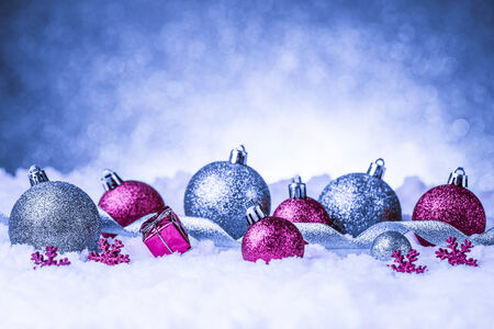 christmas ornament in snow on glitter background. studio shotの写真素材