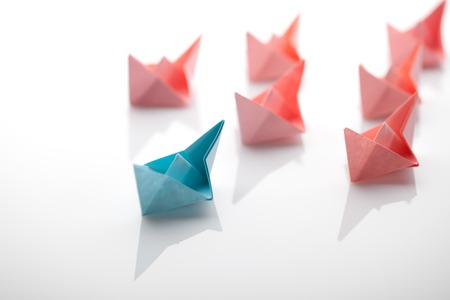 Leadership concept using paper ship among whiteの写真素材