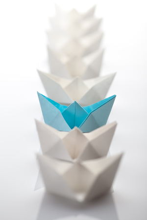Leadership concept using blue paper ship among whiteの写真素材