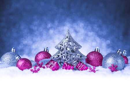 christmas ornament in snow on glitter background. studio shotの写真素材