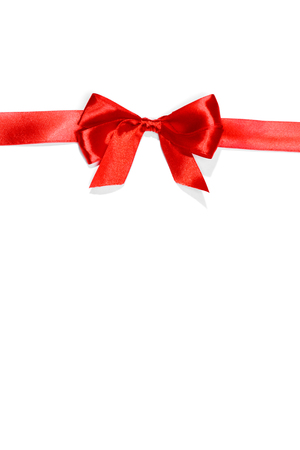 Red ribbons with bow with tails isolated on white backgroundの写真素材