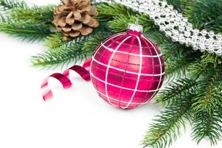 Christmas ball and fir branches with decorations isolated over whiteの写真素材