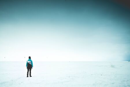 Lonely woman on the shore. Outdoor shotの写真素材