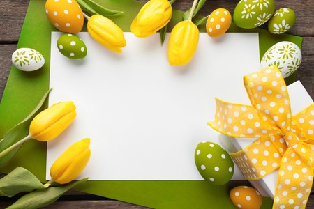 Easter background with colorful eggs over white woodの写真素材
