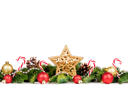 Christmas Border - tree branches with golden balls, candy and big star isolated on white, horizontal bannerの写真素材