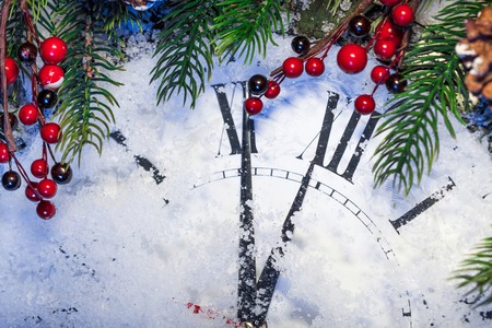 Christmas clock and decoration on snow. Happy new year conceptの写真素材