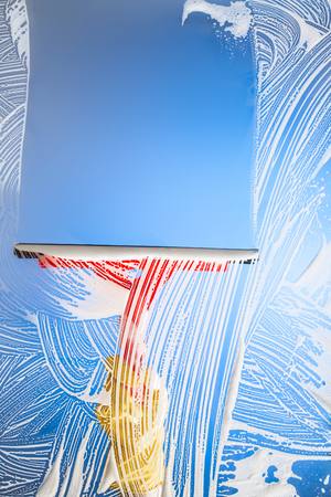 cleaning window with squeegee blue skyの写真素材