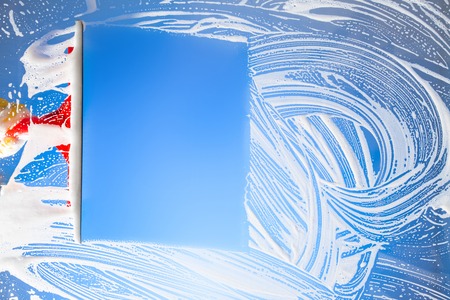 cleaning window with squeegee blue skyの写真素材