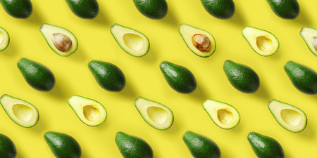 Avocado pattern on yellow background. Pop art design, creative summer food concept. Green avocadoes,...