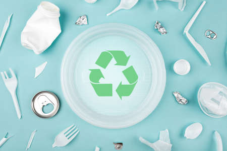 Different plastic trash and garbage recycling sign on a blue background, top view. The concept of saving the planet, the separation of garbage.の写真素材