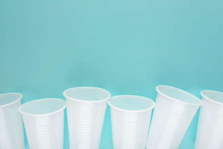 White plastic empty cups laid out in a rowの写真素材