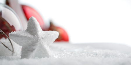 White star with red christmas decorations in snow, copy spaceの写真素材