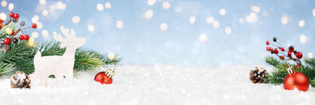 Christmas decorations with gold lights in a snowdriftの写真素材