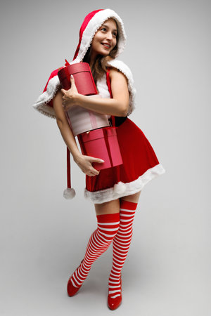 Beautiful happy woman holding a Christmas giftsの写真素材