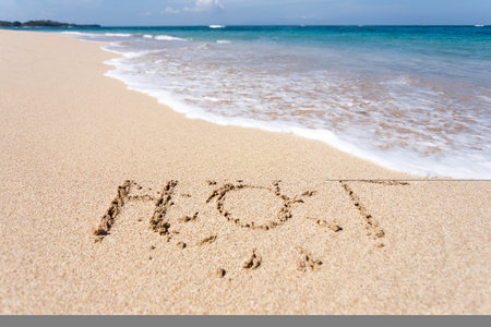 The word HOT written in the sand on beachの写真素材