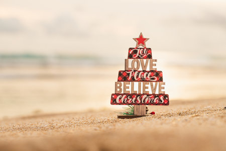 Christmas wooden toy tree on the beachの写真素材