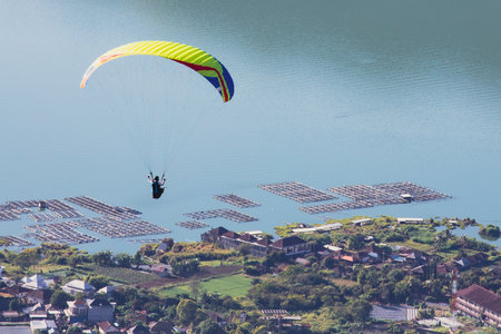 Paraglider flies in front of the ocean