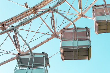 Close-up of a white ferris wheel against the sky
