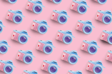 Pattern with camera on pastel color background, top view