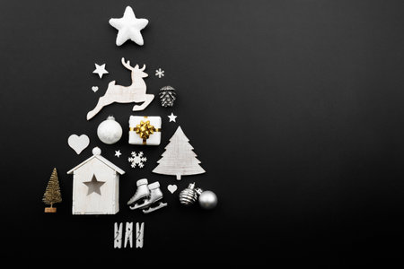 Christmas tree made of decorations on black background, copy spaceの写真素材