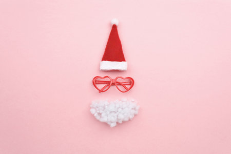 Santa hat, beard and glasses on color background top view. Flat lay.の写真素材