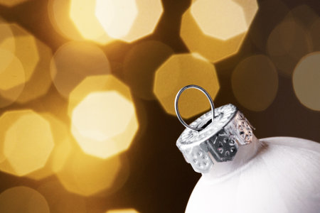 Christmas ball close-up against a background of sparkling garlandsの写真素材