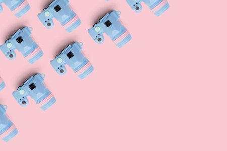 Pattern with camera on pastel color background, top viewの写真素材