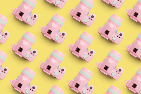 Pattern with camera on pastel color background, top view