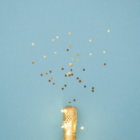 Champagne bottle with garlands on color background, top viewの写真素材