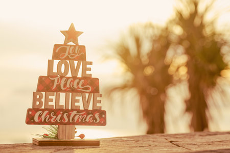 Wooden christmas tree toy on the beach. rustic styleの写真素材