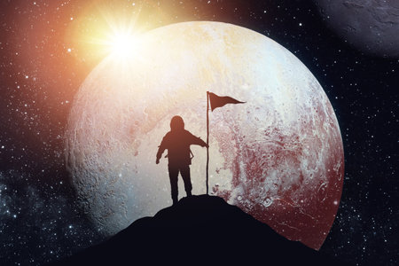 Silhouette of a man on the top of a mountain against the background of the galaxyの写真素材