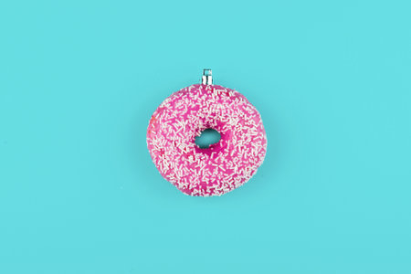 Pink donut on color background, flat lay, top viewの写真素材