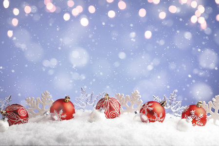 Christmas balls and snowflake with snow on color backgroundの写真素材