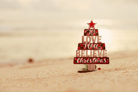 Wooden christmas tree toy on the beachの写真素材