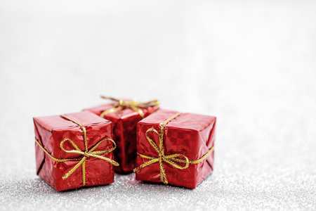 Celebration red gift boxes for decoration on glitter backgroundの写真素材