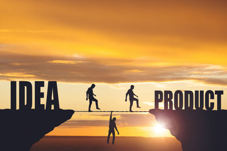 Silhouettes of people walking on a rope between rocks, success concept.の写真素材