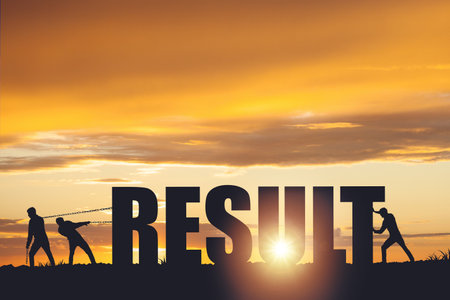Silhouettes of people drawing the word RESULT on a sunset background, business concept.の写真素材