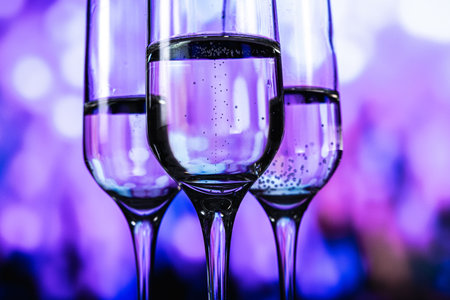 An upscale gathering characterized by illuminated drinkware and energetic social interactionsの写真素材