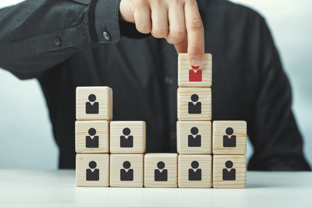 Assembled wooden cubes on the theme of business leadershipの写真素材