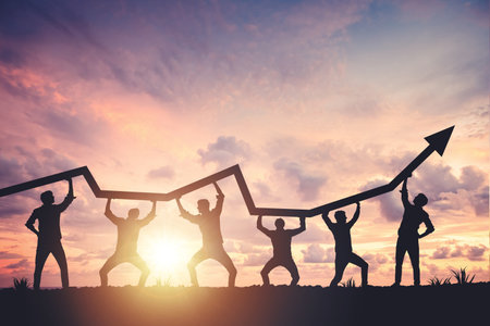 Team silhouette and up graph arrow on sunset background, leadership and teamwork conceptの写真素材