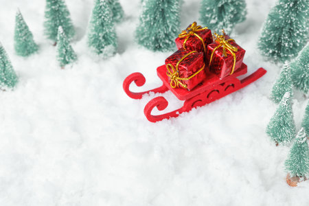 bright holiday decorations and snow, decorative red sleigh with gifts surrounded by winter landscape