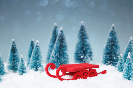 Festive holiday scene, Idyllic winter landscape displaying sled full of gifts surrounded by pine treesの写真素材