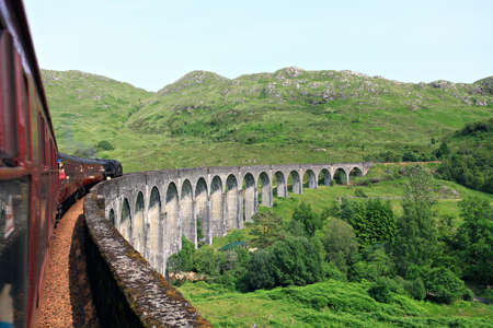 Steam train on a Glenfinnan viaduct  Scotland, UK のeditorial素材