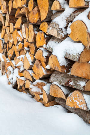 Firewood background - chopped firewood on a stackの写真素材