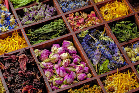 Assortment of dry herbs tea in a wooden box.の写真素材