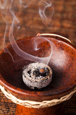 Frankincense burning on a hot coal. Frankincense is an aromatic resin, used for religious rites, incense and perfumes.の写真素材