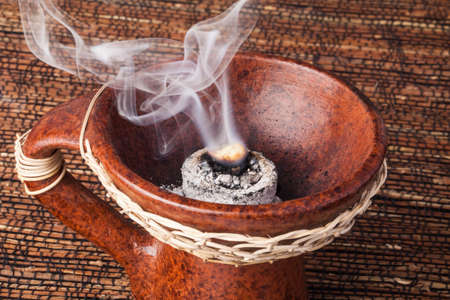 Frankincense burning on a hot coal. Frankincense is an aromatic resin, used for religious rites, incense and perfumes.の写真素材