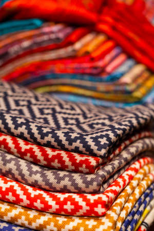 Colorful silk and wool scarfs in a marketの写真素材