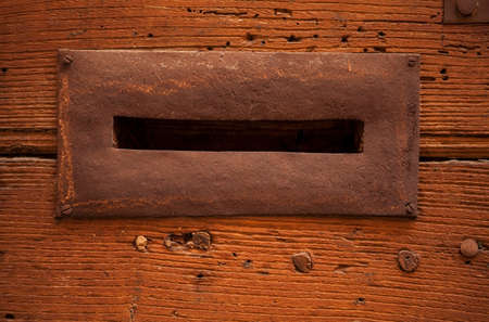 Close-up details of an antique hole for mail on the door. Rome, Italy.の写真素材